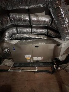 An indoor HVAC unit with new ductwork installed in a confined space by South Texas Climate Control in San Antonio, TX