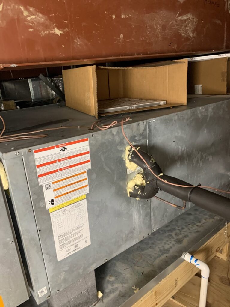 An indoor HVAC unit, possibly an air handler or furnace, during installation or repair with visible insulation and wiring by Get RiTe A/C & Heating in Madisonville, LA.