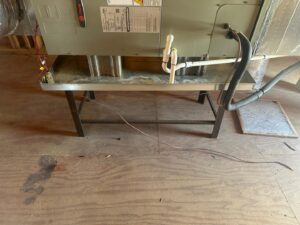 An indoor HVAC unit on a stand with a new air filter ready for installation, provided by Air Casablanca Heating & Cooling in Myrtle Beach, SC.