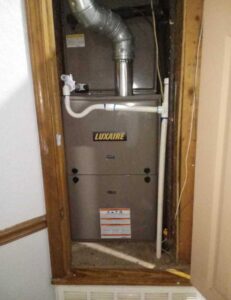 An indoor Luxaire furnace and air handler unit installed in a utility closet by TAG Heat N Air in North Little Rock, AR.