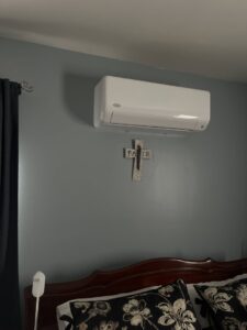 An indoor Carrier mini-split AC unit installed on a wall by Frank N Frank Mechanical Contractors in Rochester, NY.