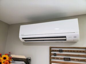 An indoor mini-split air conditioning unit mounted on a wall, installed by Furnace Doctors Heating & Air Conditioning LLC in Champaign, IL