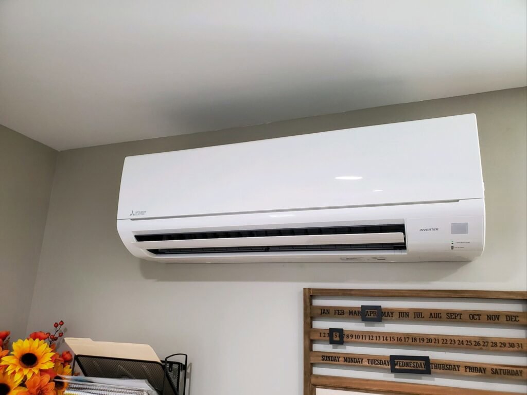 An indoor mini-split air conditioning unit mounted on a wall, installed by Furnace Doctors Heating & Air Conditioning LLC in Champaign, IL