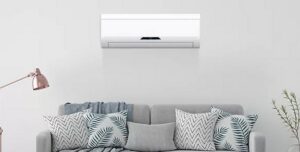 An indoor mini-split AC unit installed above a sofa by All American Heating Air & More LLC in Wilson, NC.