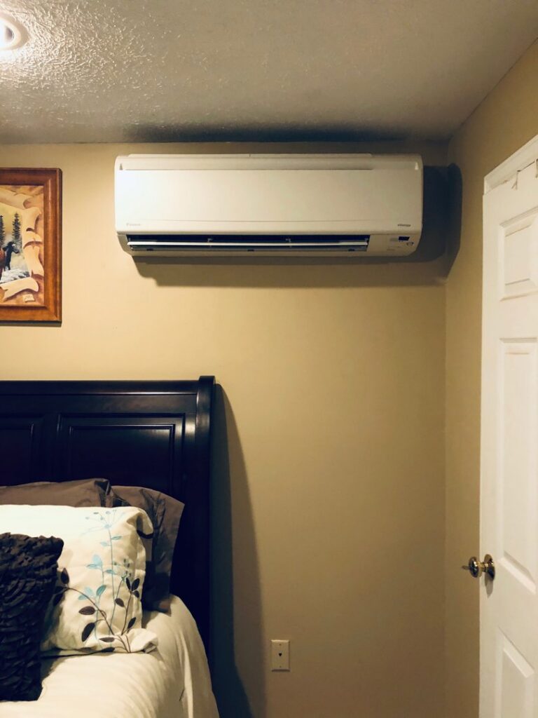 An indoor mini-split air conditioning unit installed on a wall by Derry Plumbing & Heating in Derry, NH.