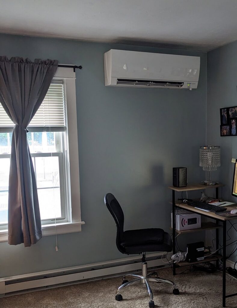 An indoor mini-split air conditioning unit installed on a wall by Heritage Home Service in Worcester, MA