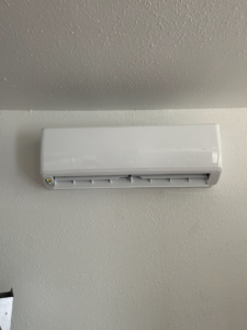 An indoor mini-split air conditioning unit installed on a wall by R&R Mechanical Services in Greeley, CO.