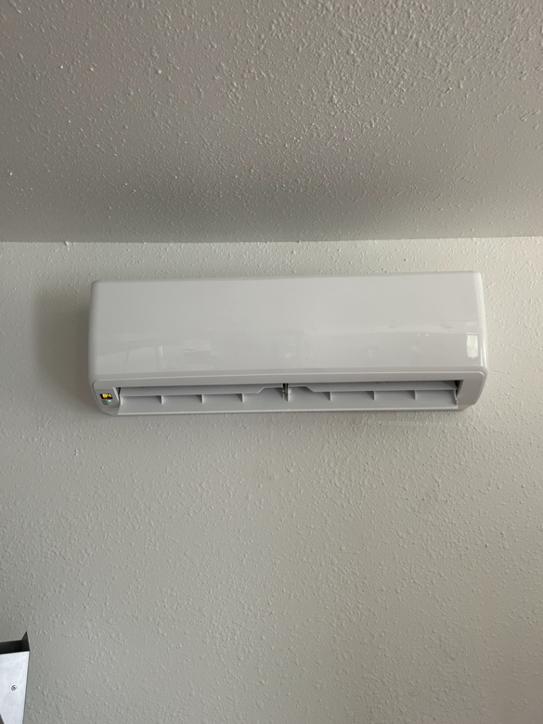 An indoor mini-split air conditioning unit installed on a wall by R&R Mechanical Services in Greeley, CO.