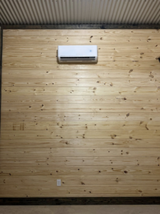 An indoor mini-split AC unit installed on a wooden wall by Spartan Air Conditioning in McIntosh, AL.