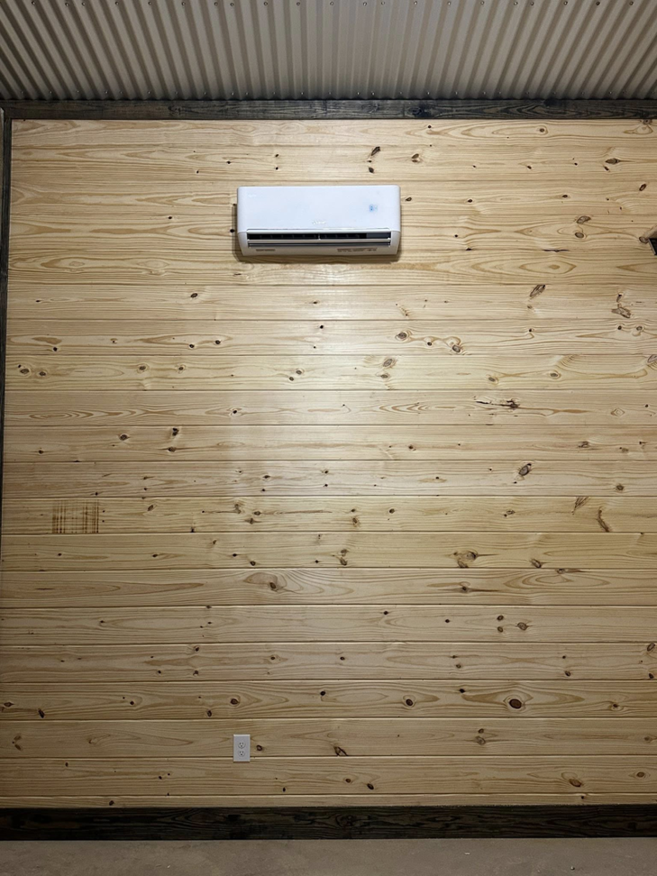 An indoor mini-split AC unit installed on a wooden wall by Spartan Air Conditioning in McIntosh, AL.