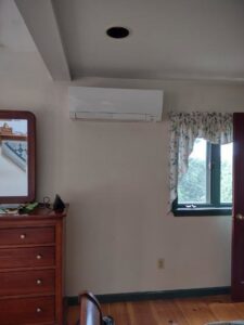 An indoor mini-split air handler unit installed in a bedroom by Hampden County HVAC Inc. in Indian Orchard, MA