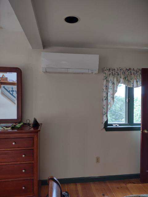 An indoor mini-split air handler unit installed in a bedroom by Hampden County HVAC Inc. in Indian Orchard, MA