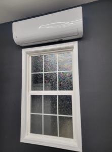 An indoor mini-split air handler unit installed above a window by Smoky Mountain Ducts & Vents in New Market, TN.