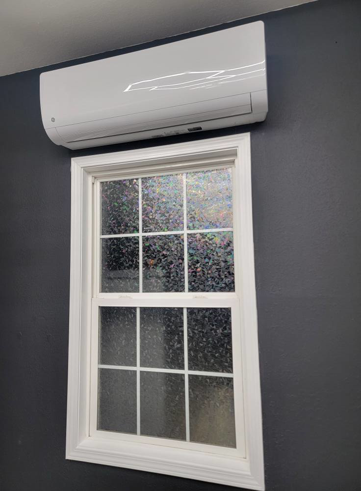 An indoor mini-split air handler unit installed above a window by Smoky Mountain Ducts & Vents in New Market, TN.
