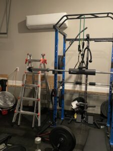 An indoor mini-split air conditioning unit installed in a home gym or garage by Elite Home Comfort in Clarksville, TN