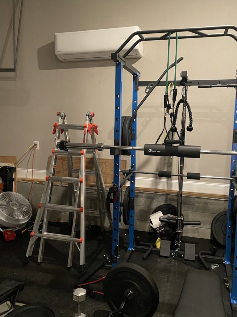 An indoor mini-split air conditioning unit installed in a home gym or garage by Elite Home Comfort in Clarksville, TN