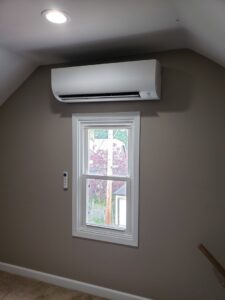 An indoor mini-split head unit professionally installed above a window by 9-1-1 Heating & Air, LLC for zoned cooling in Milwaukee, WI.