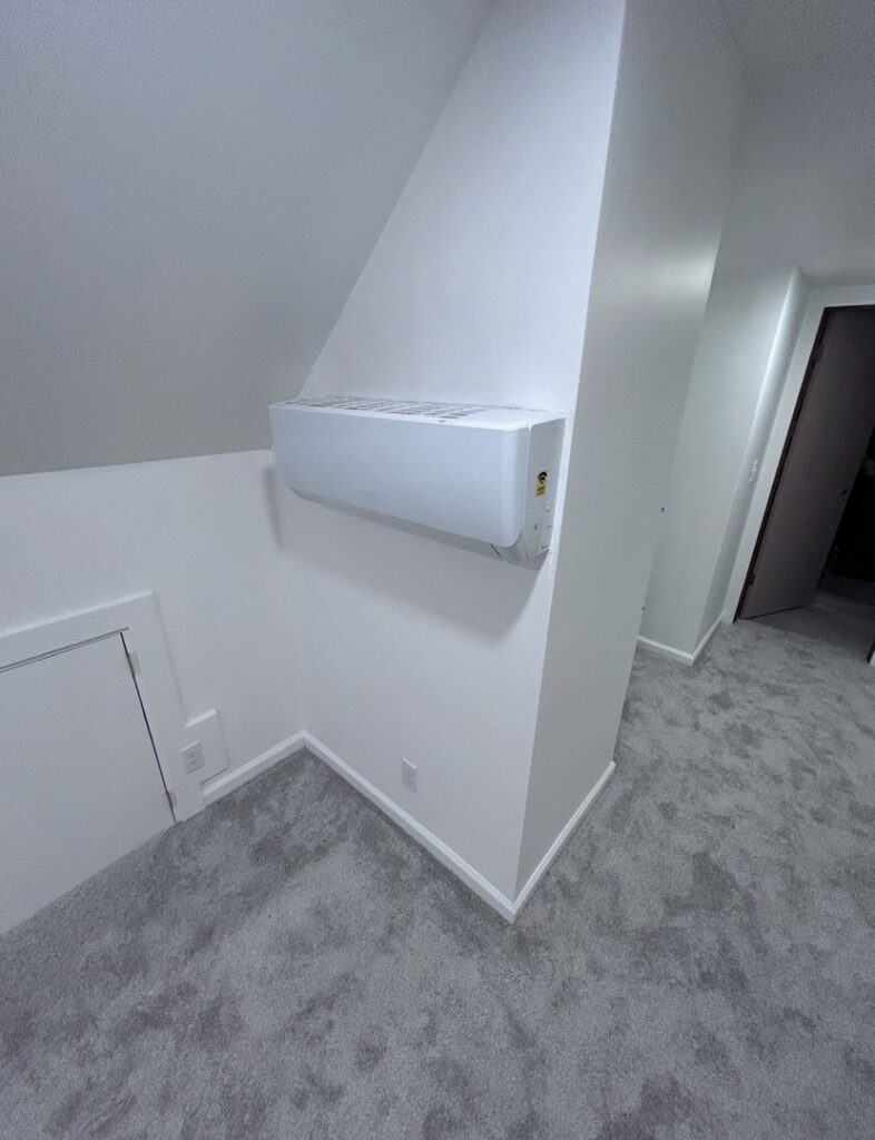 An indoor mini-split head unit installed on a wall by Affordable Heating & Cooling LLC in Olathe, KS.