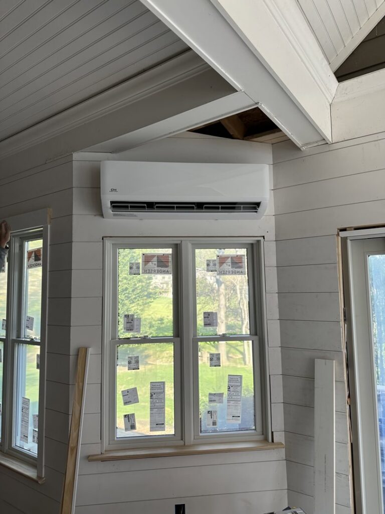 An indoor mini-split head unit installed above windows by P3 Mechanical Heating & Cooling in Bainbridge, PA.