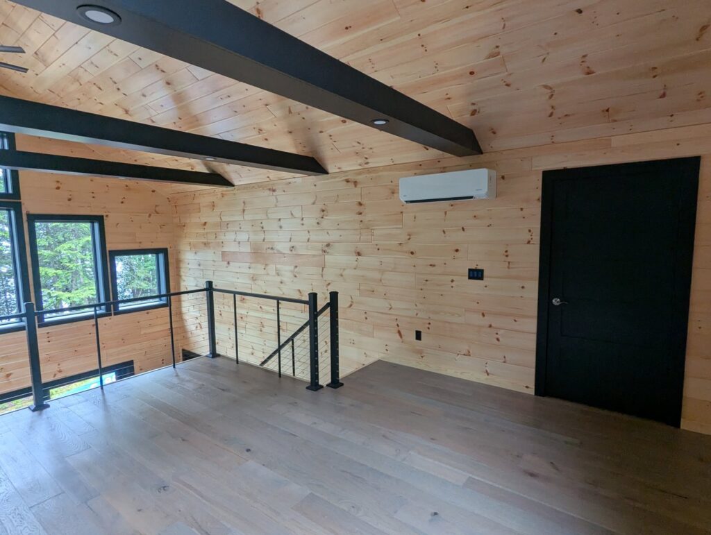 An indoor mini-split heat pump head unit installed in a finished room by Kinney Family Heat Pumps in Augusta, ME.