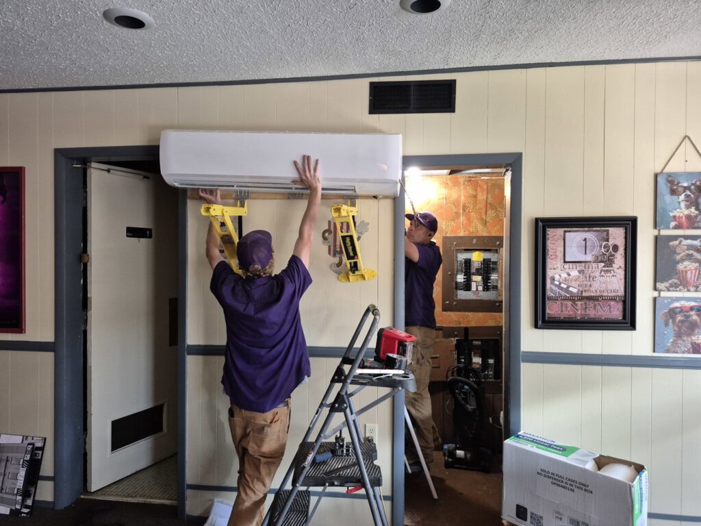 Milan Heating & Air technicians installing an indoor mini-split HVAC unit in a home in Milan, TN.