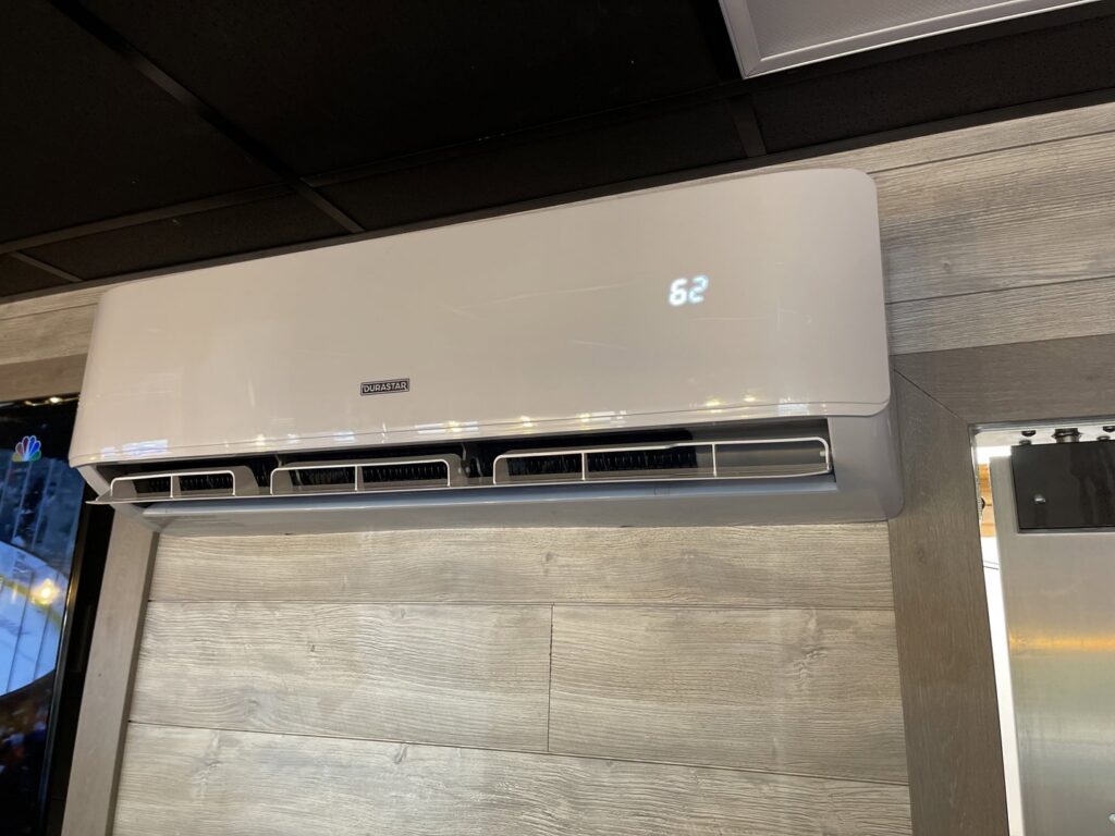 An indoor mini-split HVAC unit installed on a decorative wooden wall by Jones Heating and Refrigeration in Dickinson, ND.