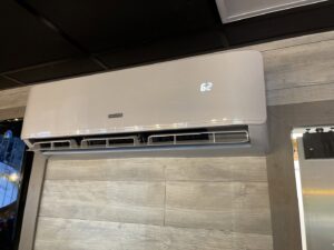 An indoor mini-split HVAC unit installed on a decorative wooden wall by Jones Heating and Refrigeration in Dickinson, ND.