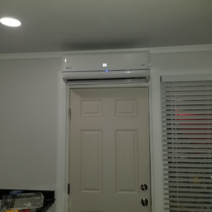 An indoor mini-split HVAC unit installed above a door, showing the temperature, by A.C. Installing in Roanoke, VA.