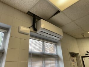 An indoor mini-split HVAC unit installed high on a wall above a window by Underwood Heating and Air Conditioning in Phenix City, AL
