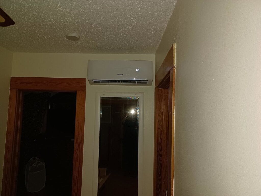 An indoor mini-split air conditioning unit installed above a doorway, showing HVAC work by Jones Heating and Refrigeration in Dickinson, ND.