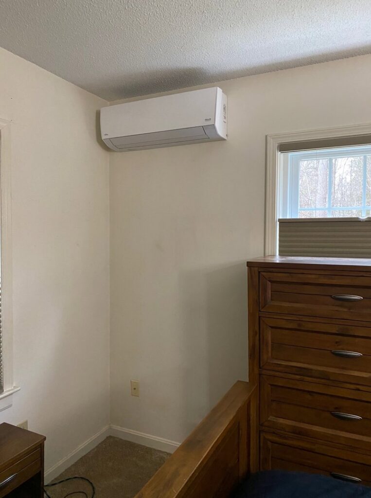 An indoor mini-split heat pump unit installed in a bedroom by Champlain Valley Heat Pump, LLC in Colchester, VT.