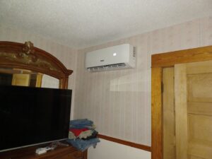 An indoor mini-split air conditioning unit mounted on a bedroom wall, installed by Jones Heating and Refrigeration in Dickinson, ND.