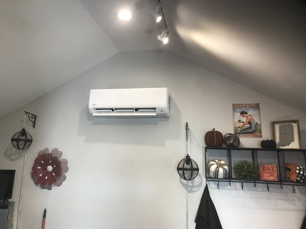 An indoor mini-split air conditioning and heating unit mounted on a wall by Chad Byers - Edge Guys Heating & Cooling in Carmel, IN.