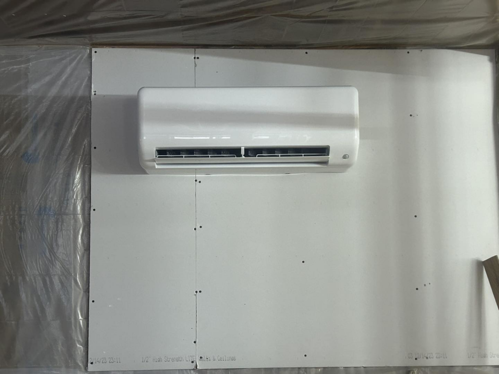 An indoor mini-split air handler unit installed on a wall under construction by BRY Heat and Air in Elgin, MN