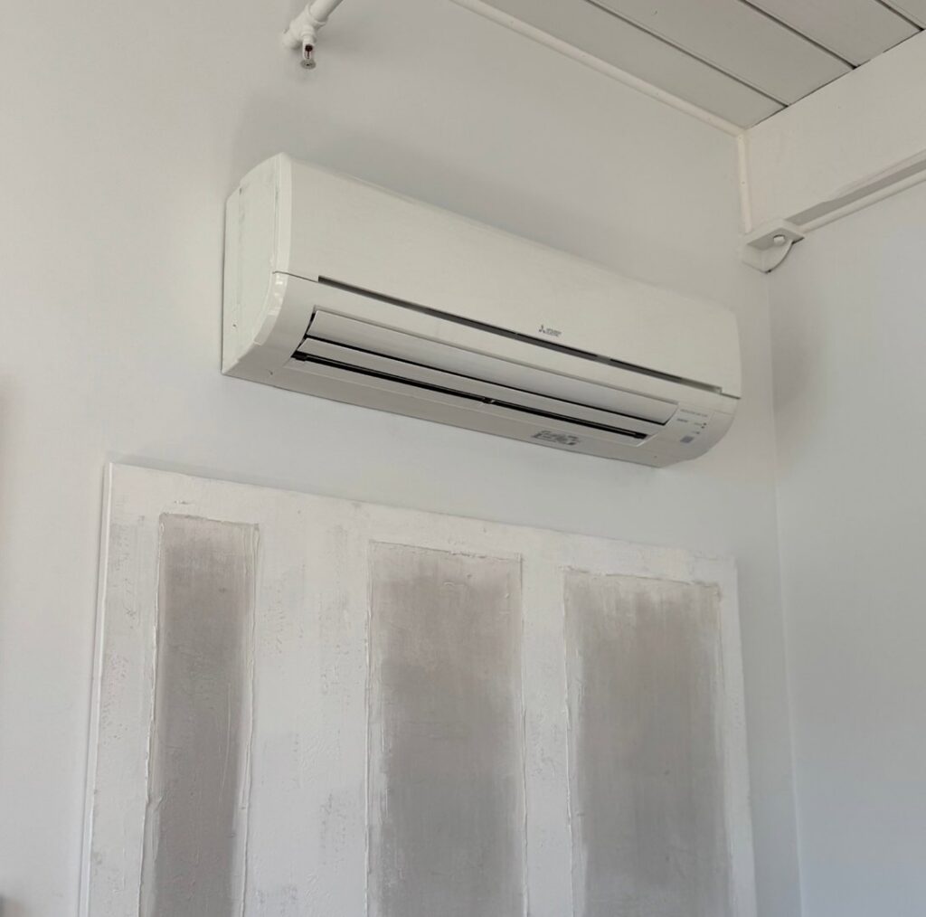 An indoor Mitsubishi mini-split unit installed on a wall by Comfort Systems and Solutions in Coventry, RI