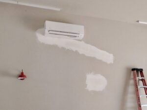 An indoor mini-split unit installed on a wall, showing recent work by Lee's Heating & Cooling in Pueblo, CO.