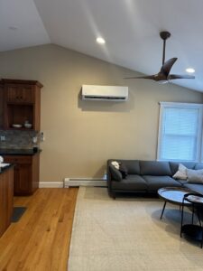 A newly installed indoor mini-split air conditioning unit mounted on a wall in a modern living space by Indoor Expert Heating & Cooling in Paterson, NJ.