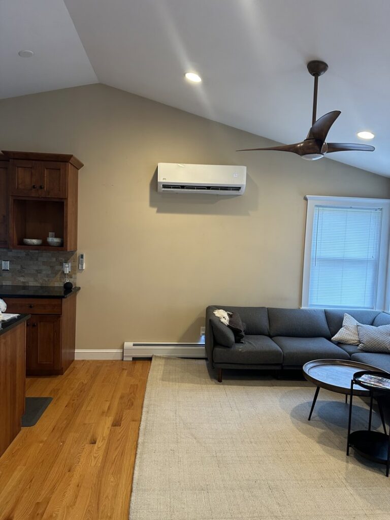 A newly installed indoor mini-split air conditioning unit mounted on a wall in a modern living space by Indoor Expert Heating & Cooling in Paterson, NJ.