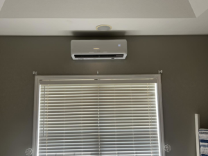 Indoor mini-split unit installed above a window by That Air Conditioning Company LLC in Dothan, AL