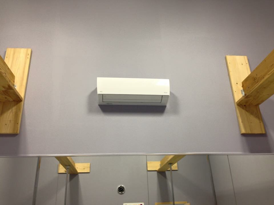 An indoor mini-split air conditioning unit installed on a wall by The Heating Guys in Fargo, ND.