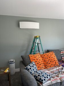 An indoor mini-split unit installation with a green ladder nearby by DiMartino's 5 Star Heating & Air Conditioning LLC in Salem, OR.