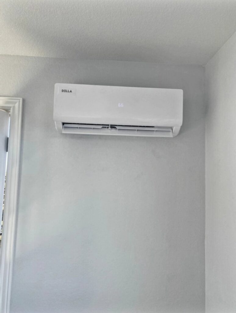 An indoor Della mini-split air conditioning unit mounted on a wall, installed by Thin Air Heating and Cooling in Arvada, CO.
