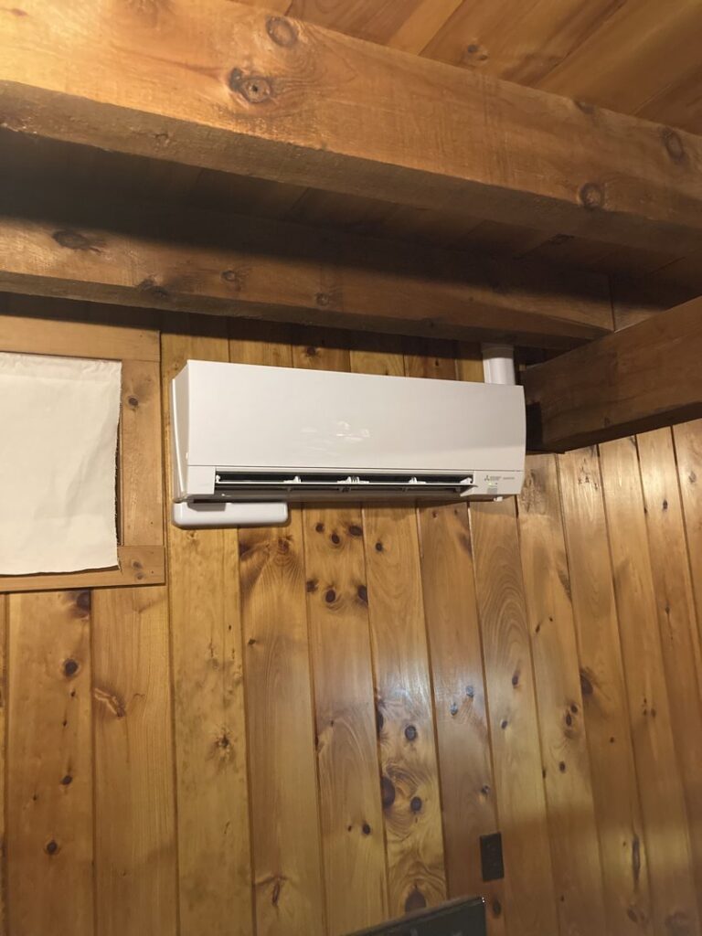 An indoor mini-split unit installed on a wooden wall, showcasing a clean HVAC installation by A&D Ductless LLC in Lunenburg, MA.