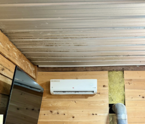 An indoor mini-split air conditioning unit installed on a wooden wall by HD Precision Works in Iota, LA.
