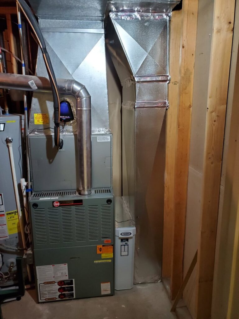 An indoor Rheem furnace and associated ductwork installed by ABT Heating and Cooling in Orem, UT.