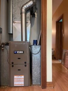An indoor YORK furnace and air handler unit with ductwork installed by MTL Heating and Cooling LLC in West Haven, CT