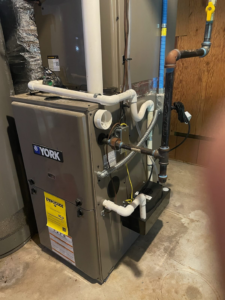 An indoor York furnace and air handler unit with ductwork, serviced by Conway's Heating & Air in Concord, NC.