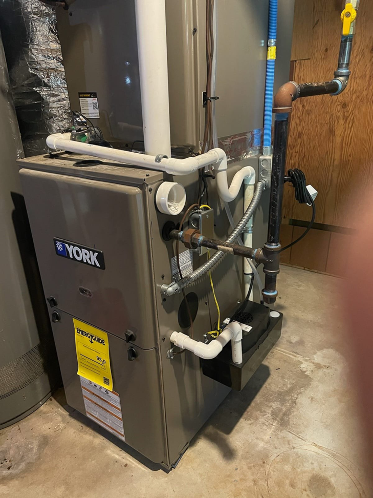 An indoor York furnace and air handler unit with ductwork, serviced by Conway's Heating & Air in Concord, NC.