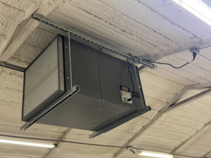 An industrial air filtration unit installed on a ceiling by Erman Mechanical in Fort Wayne, IN