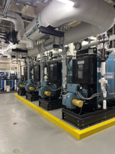 A row of industrial boilers and HVAC piping systems installed by CH McGuiness Co. Inc. in Des Moines, IA.